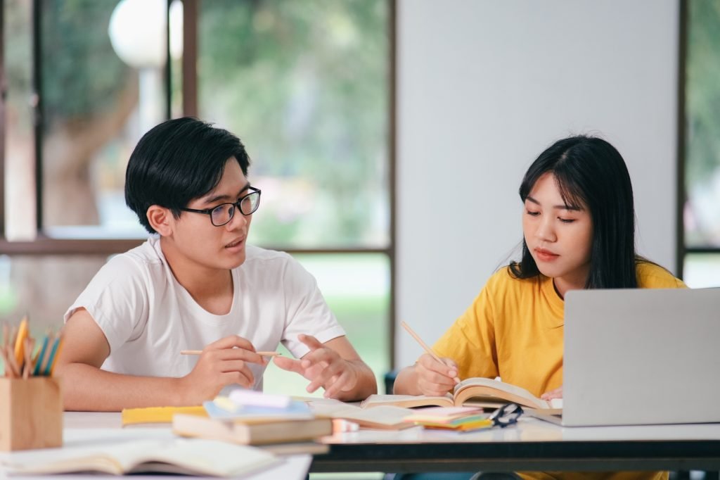 An asian students are reading books and study, Tutoring together.