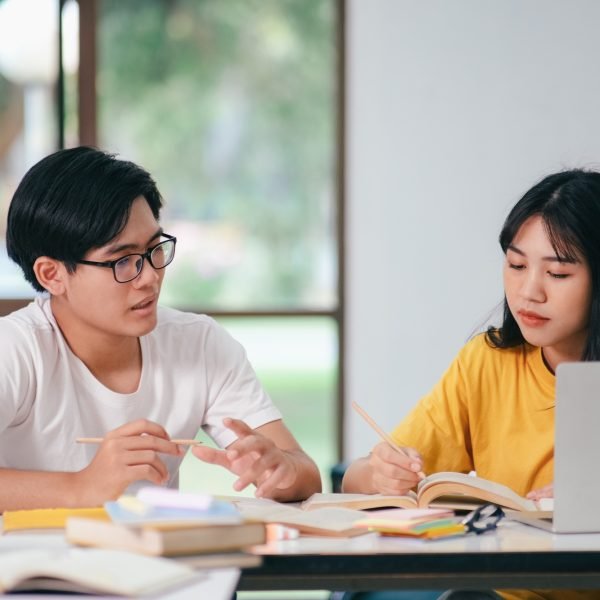 An asian students are reading books and study, Tutoring together.