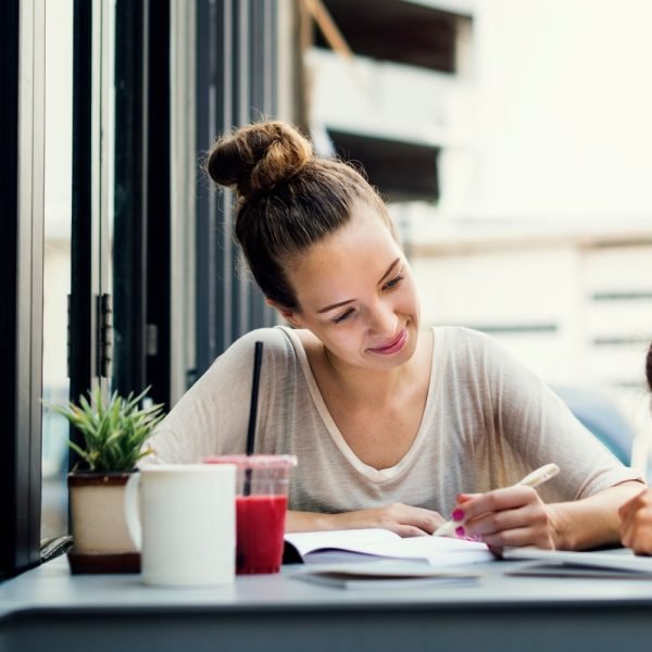 Girl with a tutor doing homework outside